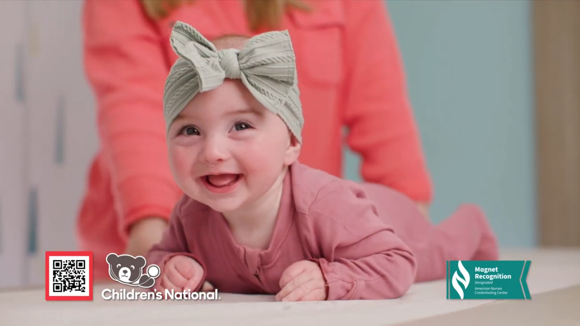 smiling baby on exam table; Children's National logo; Magnet logo