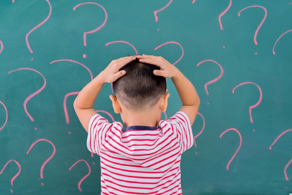 boy with hands on his head