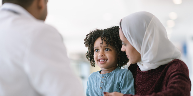 Mother accompanies child at doctor's visit.