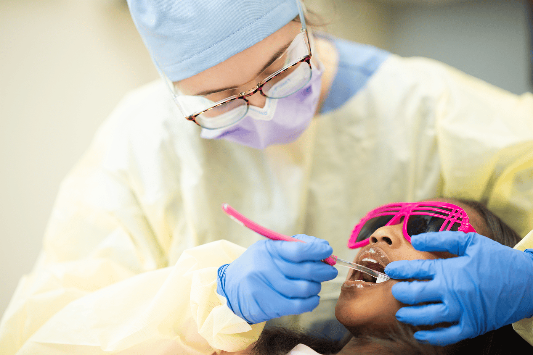Dentist cleaning a patients teeth