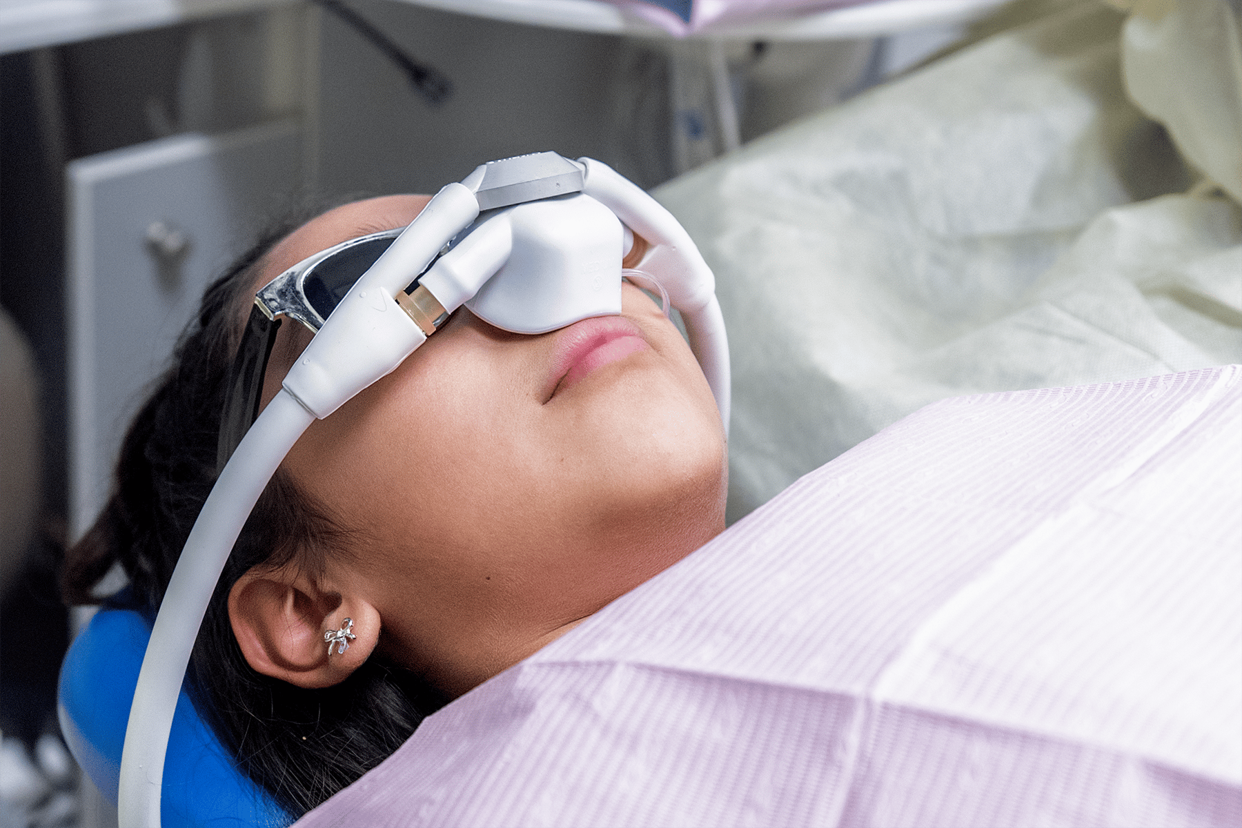 Pre-teen patient in dentist chair leaned back with a laughing gas mask on.