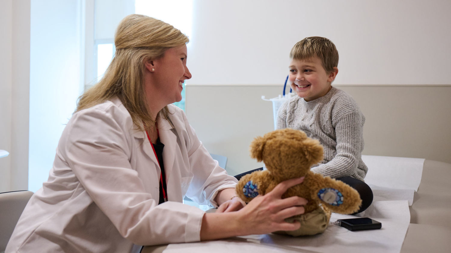 Dr. Meyers using a stuffed bear to talk to a diabetes patient