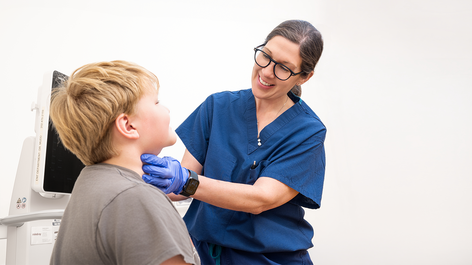 Provider checking a patients thyroid