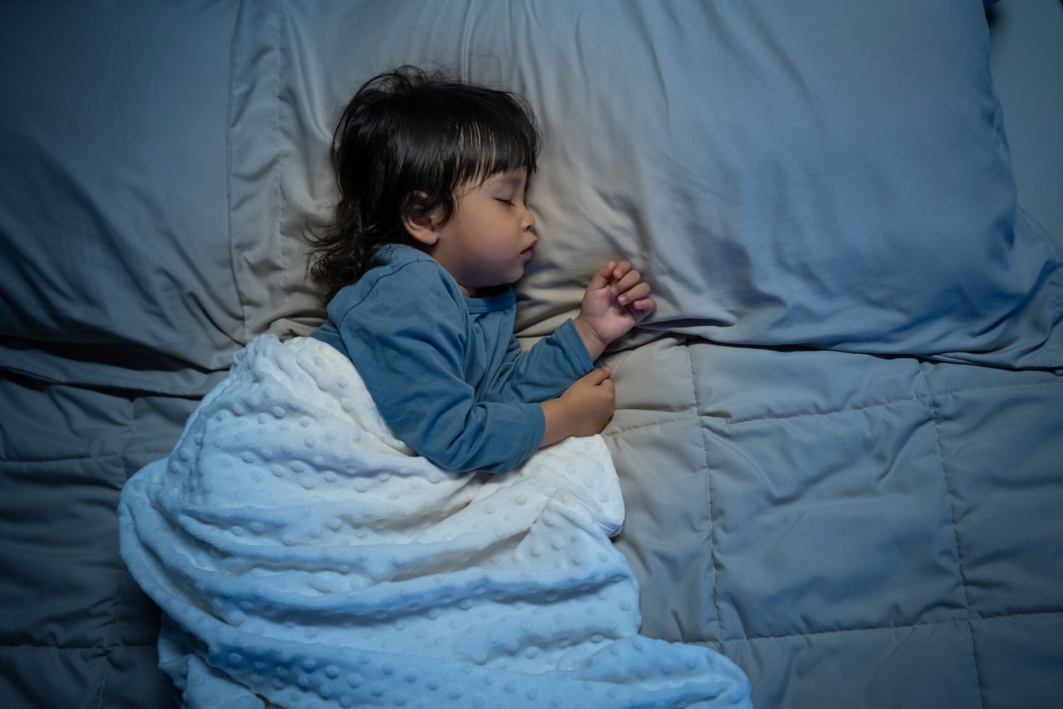 child sleeping in a bed