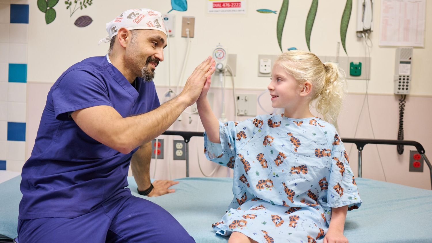 Doctor ad patient in exam high fiving