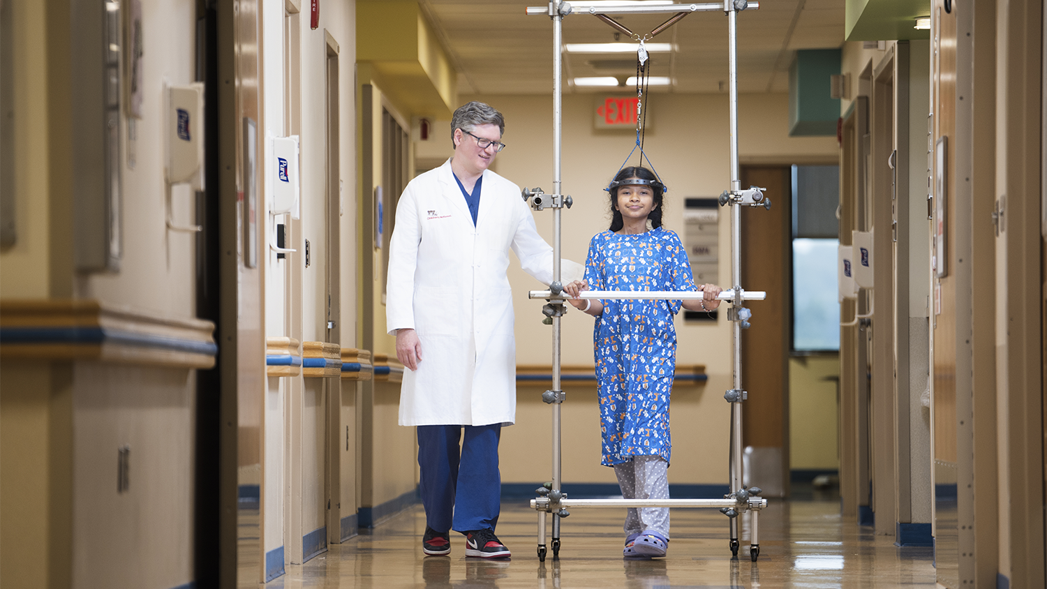 Provider with patient walking down the hallway