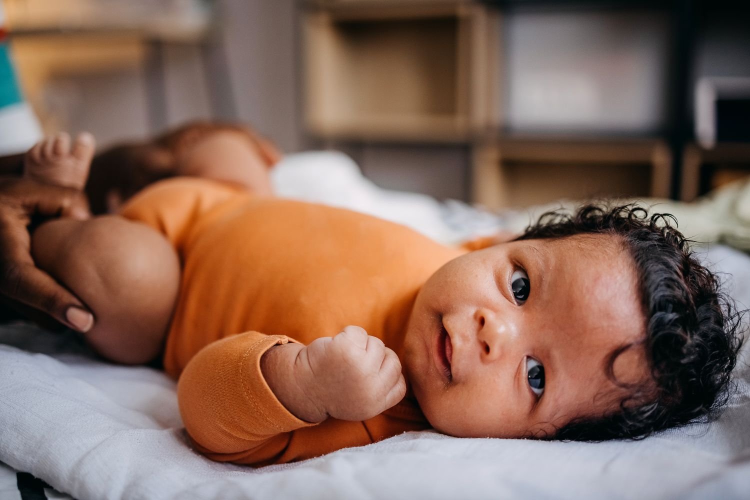 newborn baby looking at camera