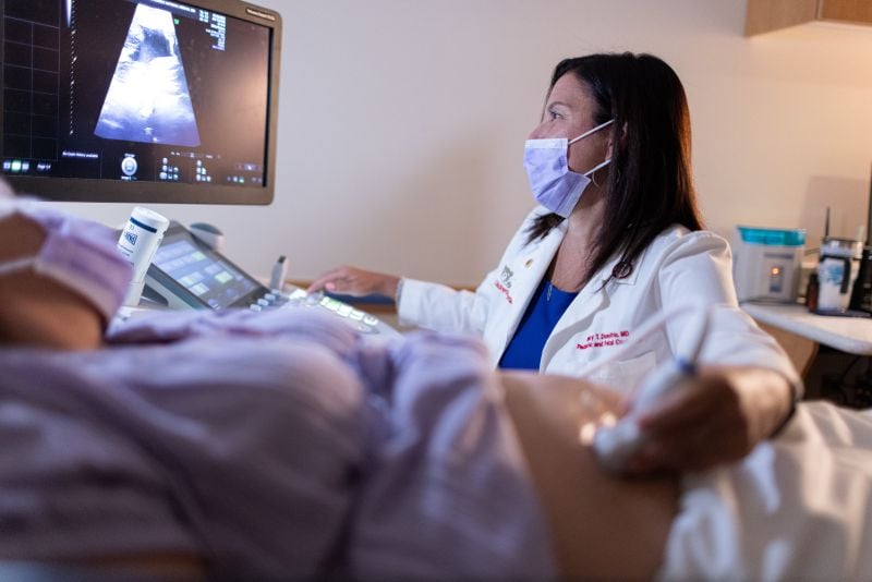 Doctor performing exam on pregnant woman