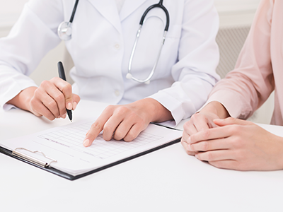 doctor and patient filling out paperwork