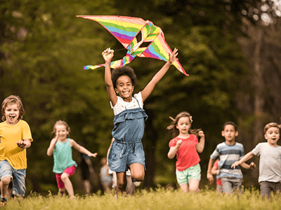 happy children running with kite
