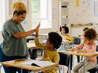 boy giving his teacher a high five