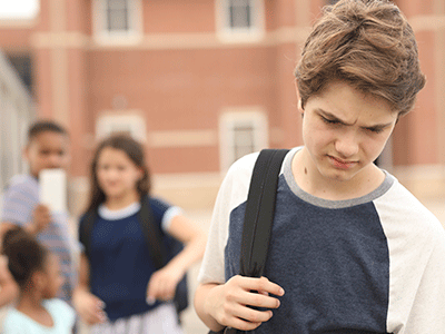 sad boy being bullied at school