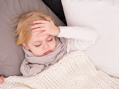 kid in bed with headache