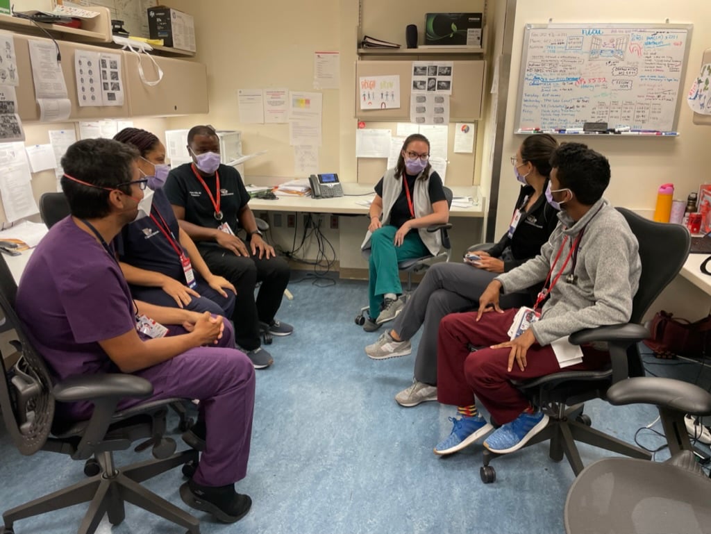 Neonatal-Perinatal Fellows meet around a table.