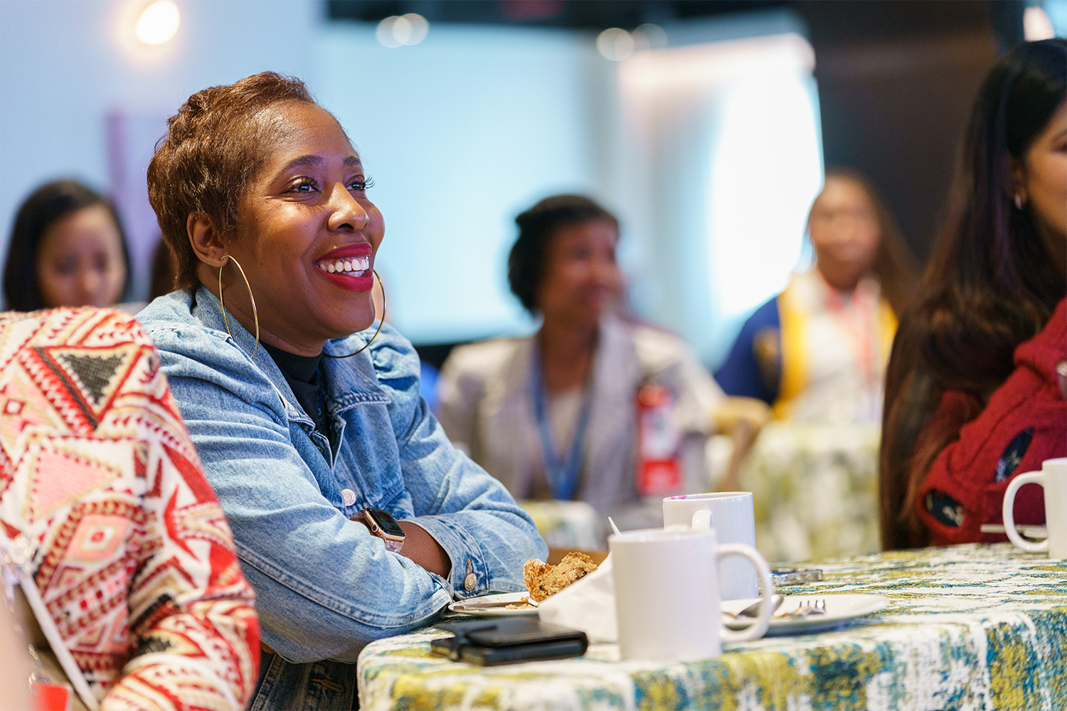 Woman sitting at a table smiling