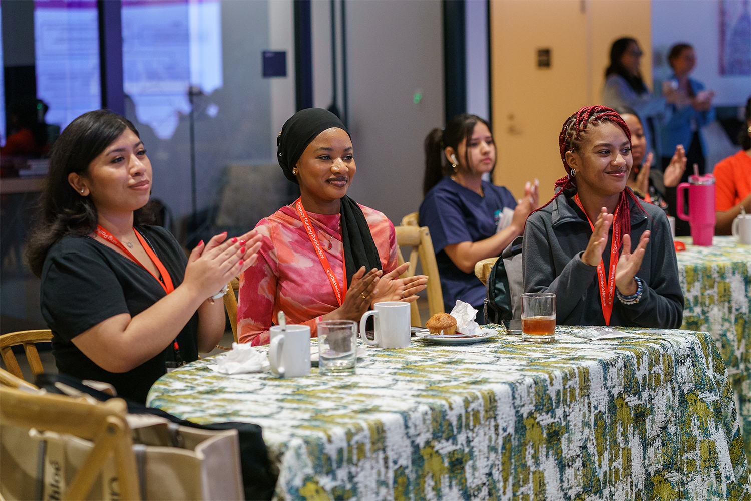 Women sitting at a table clapping
