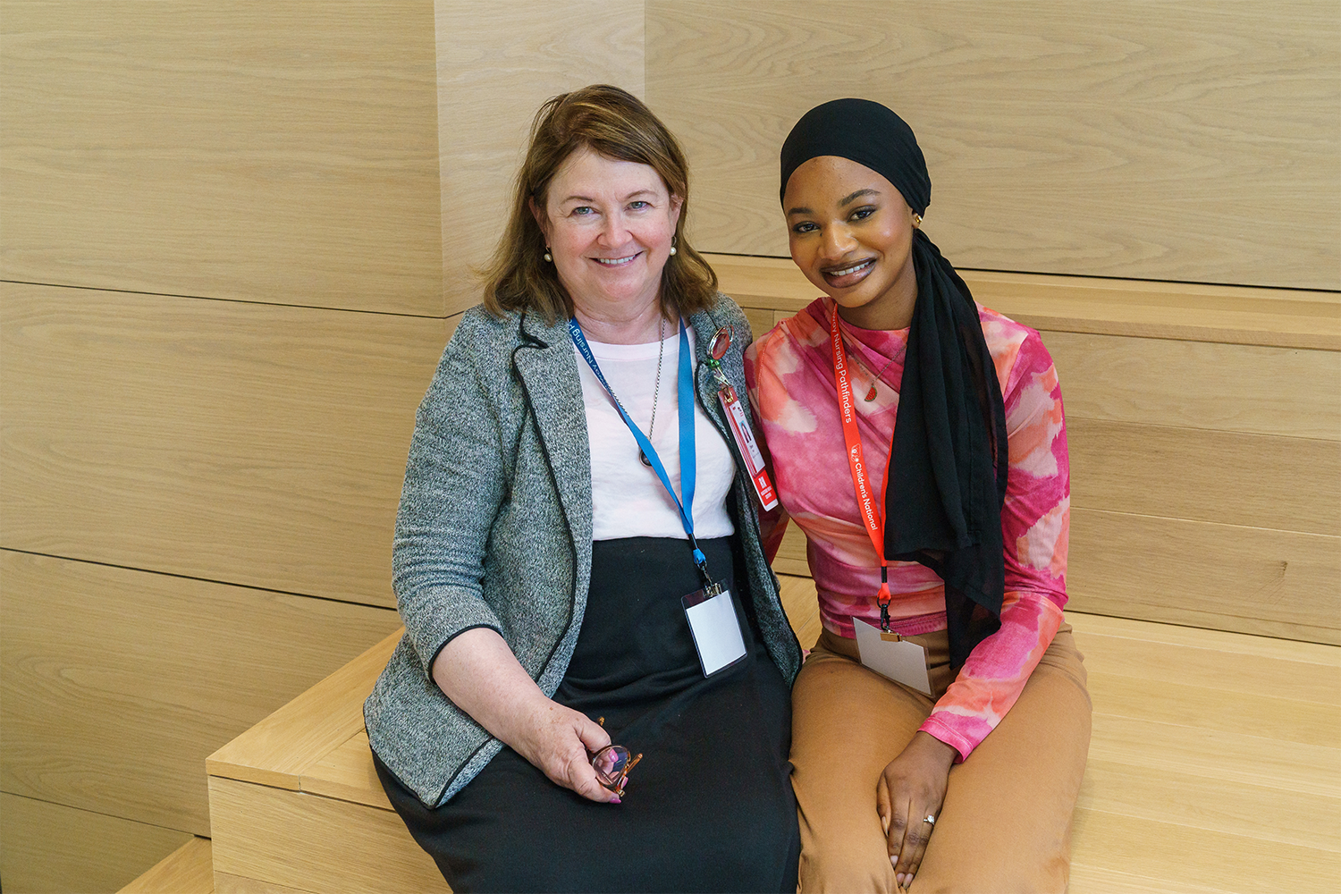 Two women sitting on a bench together