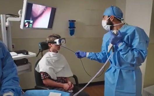 A doctor inserts a small tube down a patient's nose in a procedure to examine the esophagus and stomach