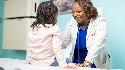 Doctor and child in a exam room.