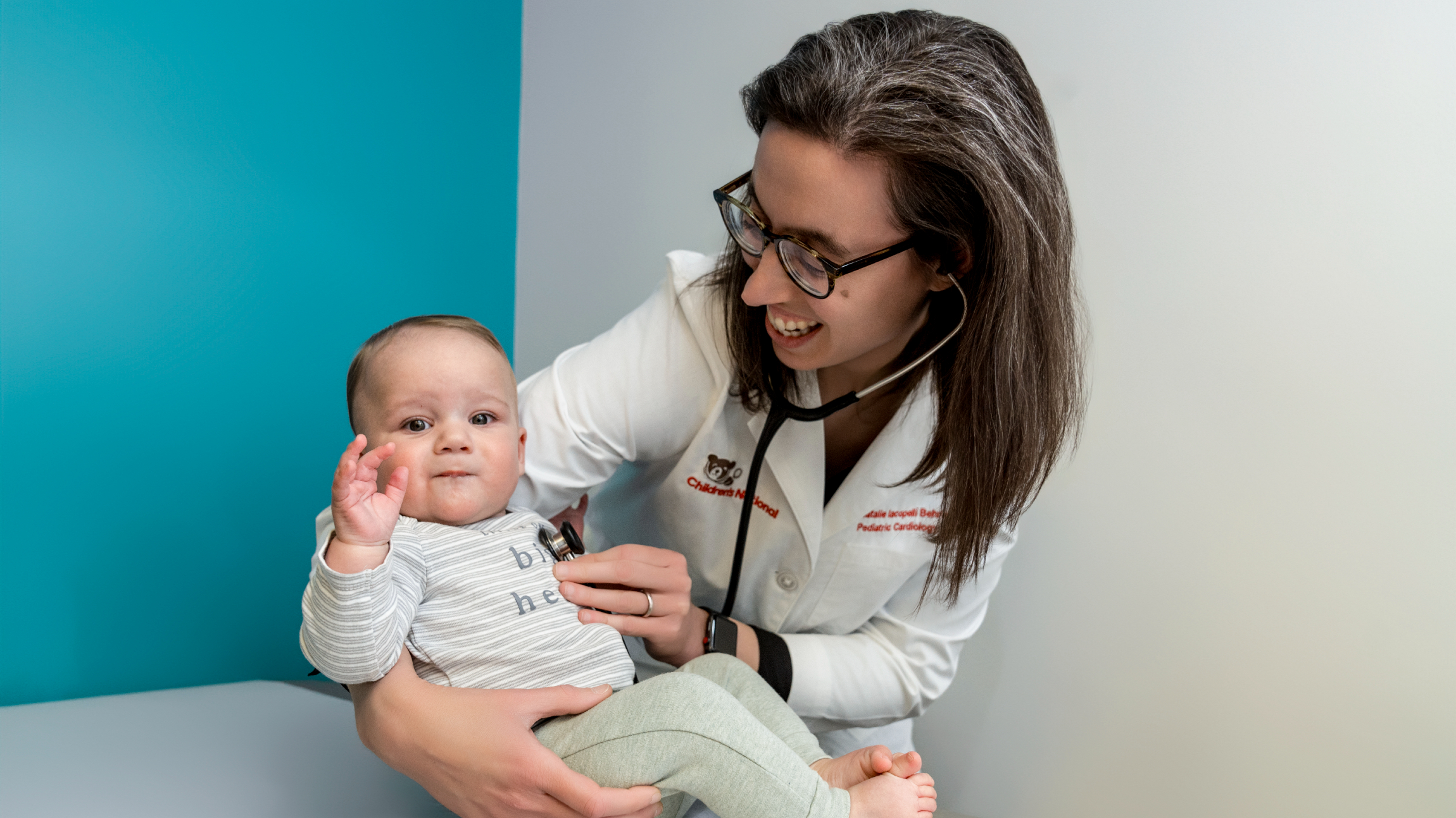 doctor listens to baby's heart