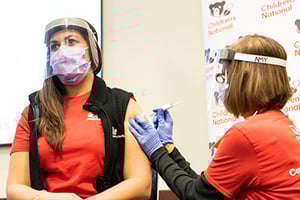 Nurse receiving COVID-19 vaccine