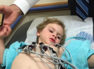 Chip laying in a hospital bed with leads on his chest