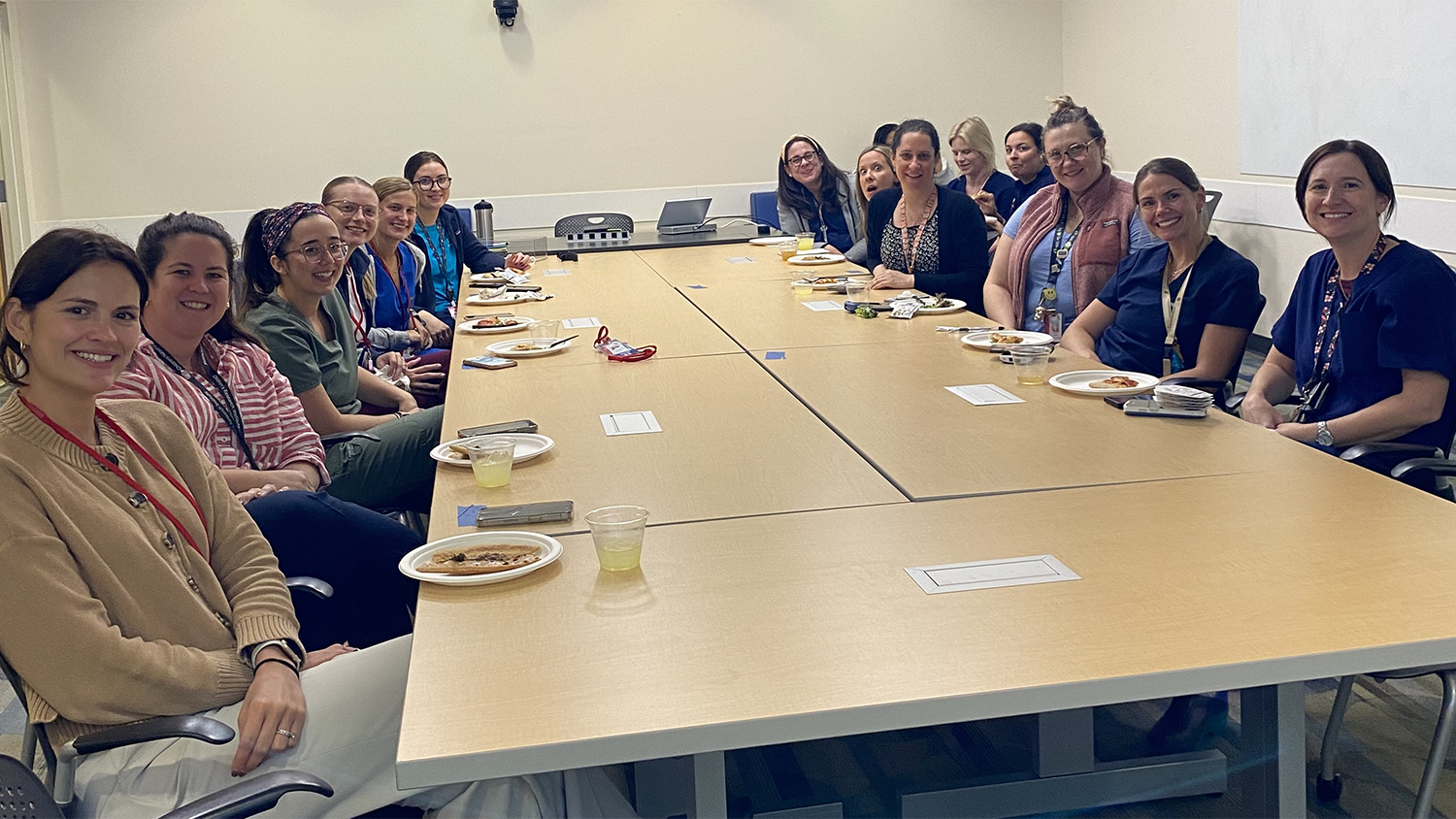 Group photo with everyone sitting at a table