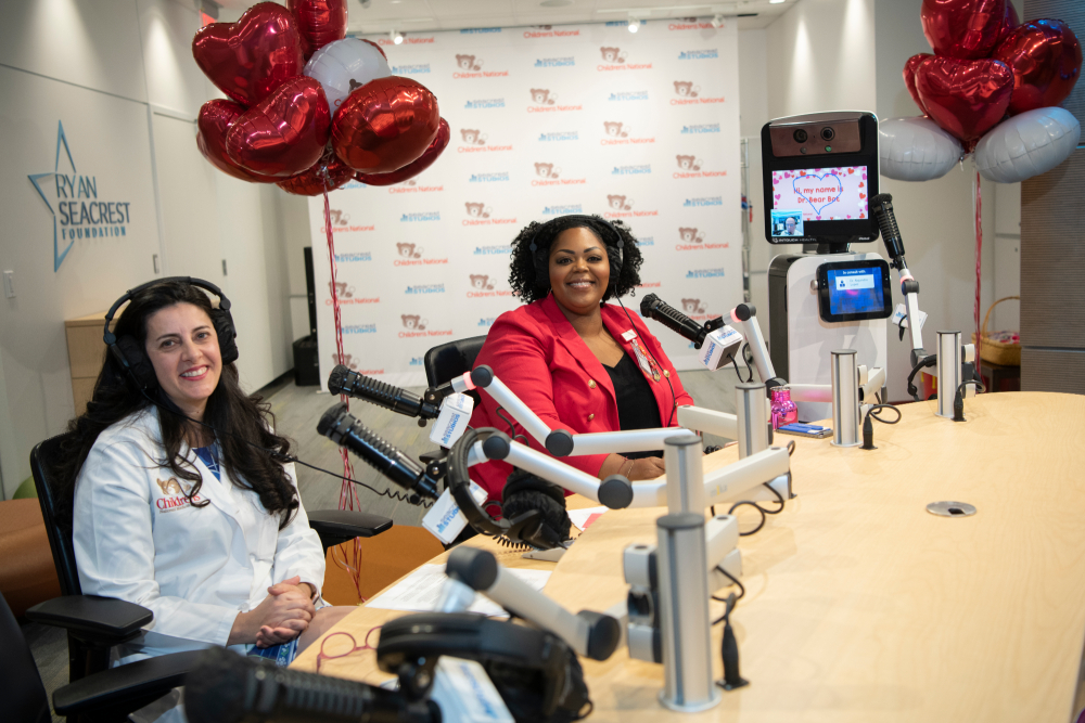 dr atabaki and monique sitting down with red balloons and dr bear bot