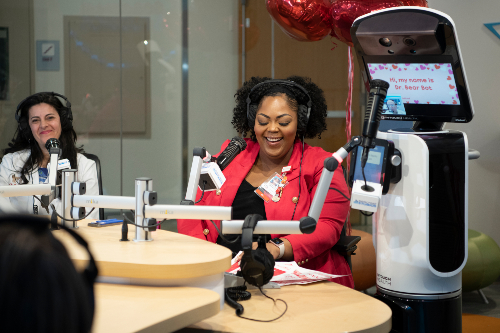dr atabaki, monique and dr bear bot speaking into microphones