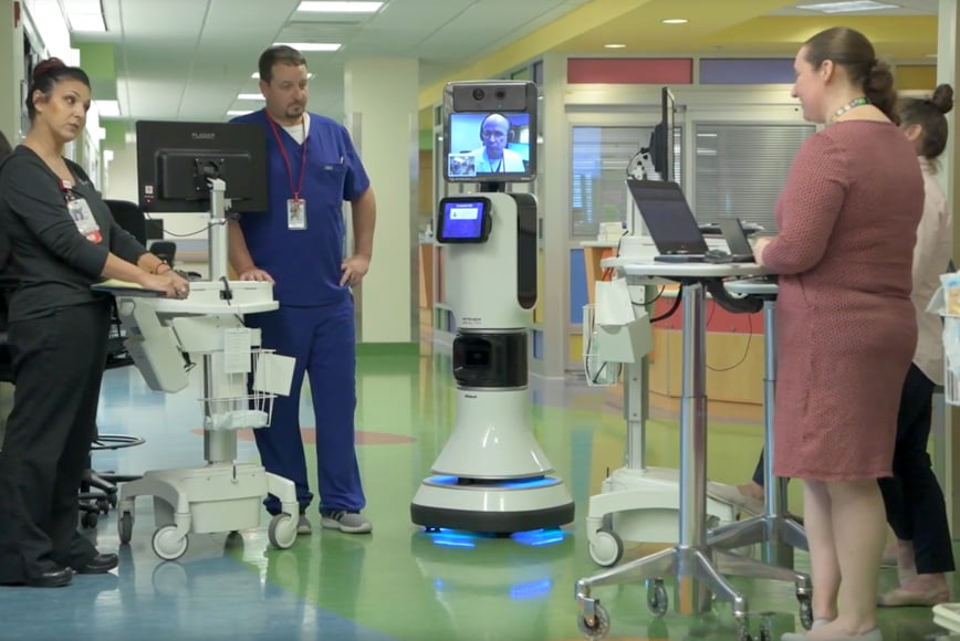 dr bear bot in hospital hallway with four doctors and nurses