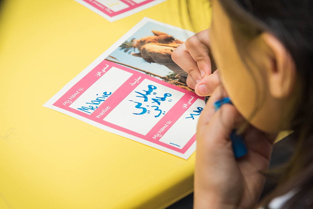 girl writing in Arabic 