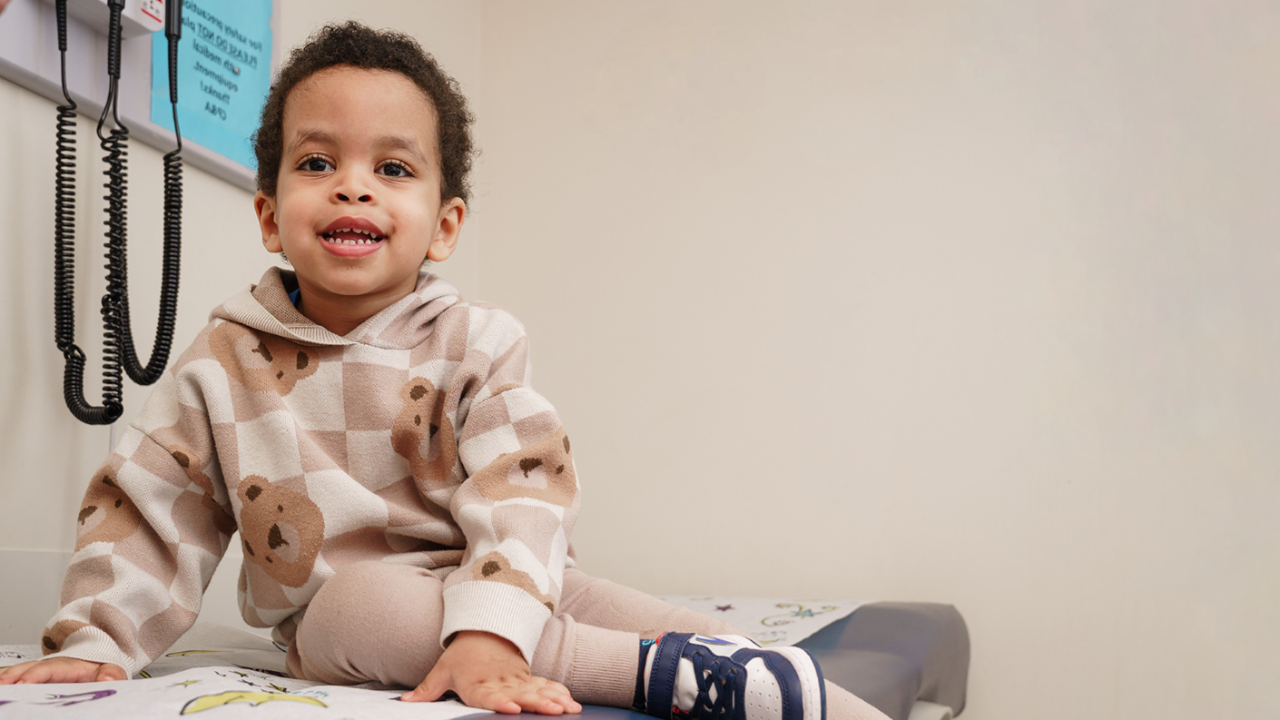young smiling boy on exam table