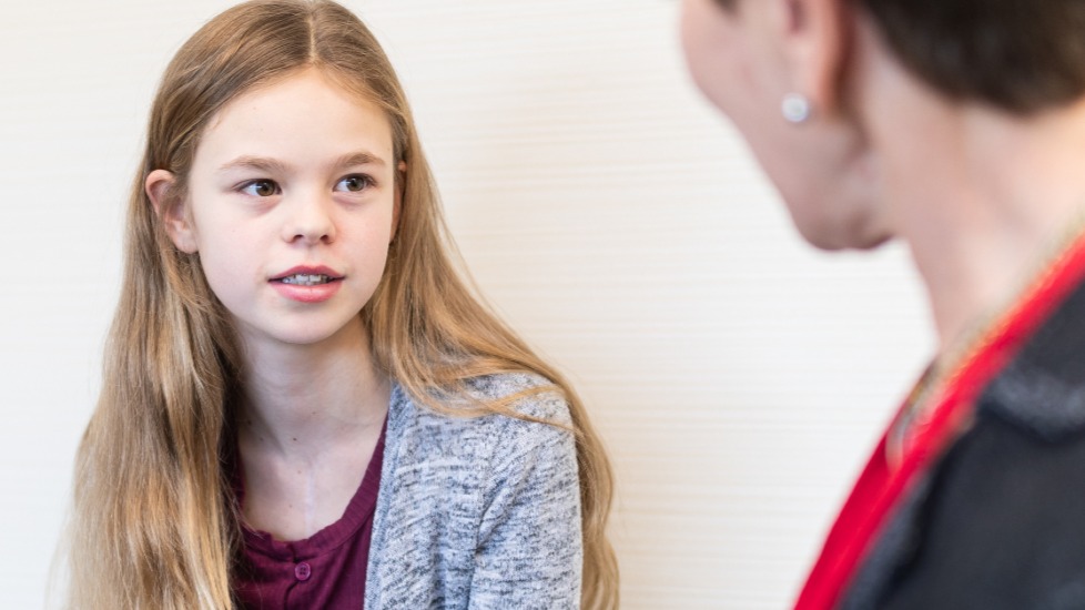 adolescent girl speaking with provider