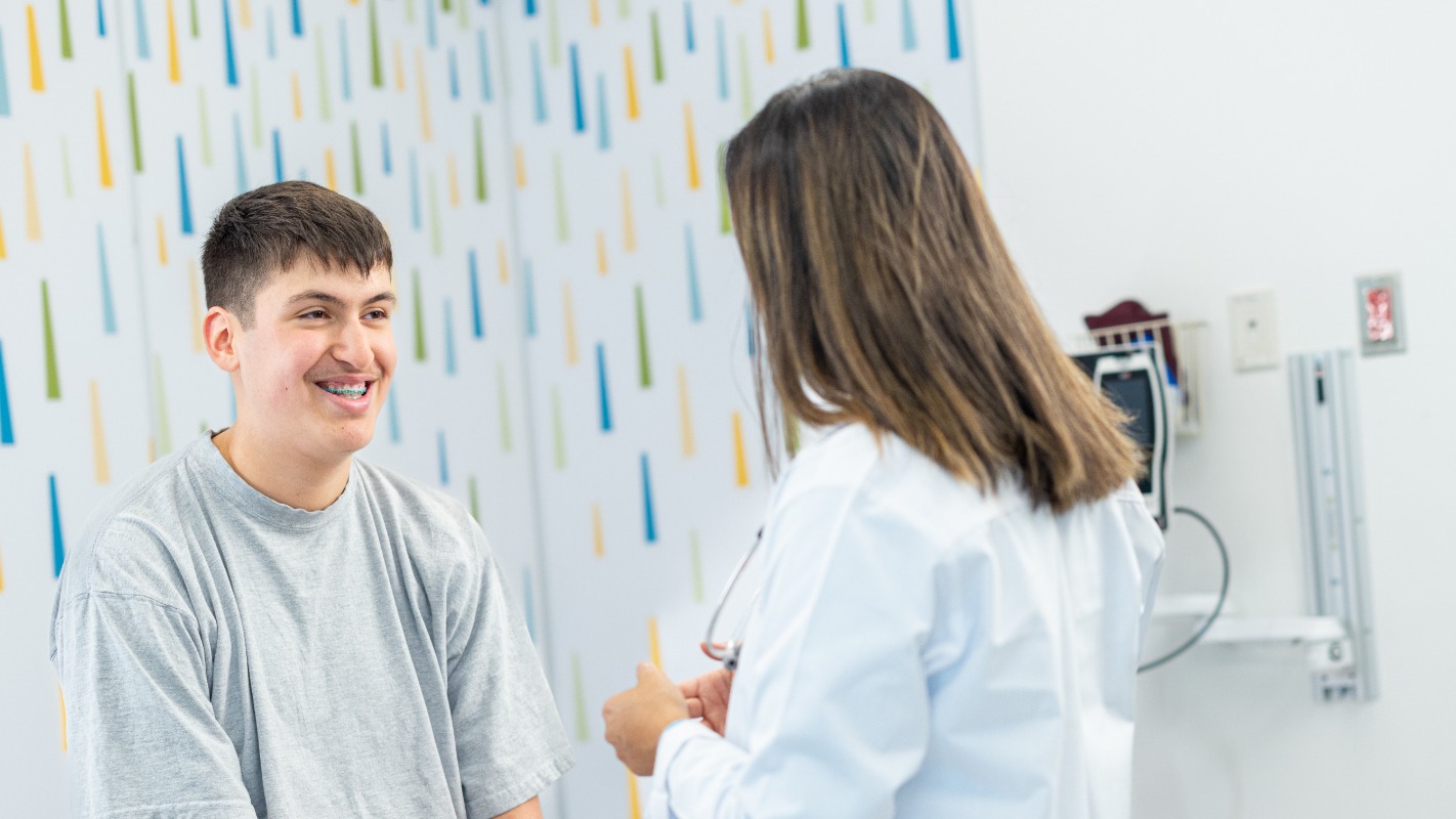 teenage boy speaking with his provider