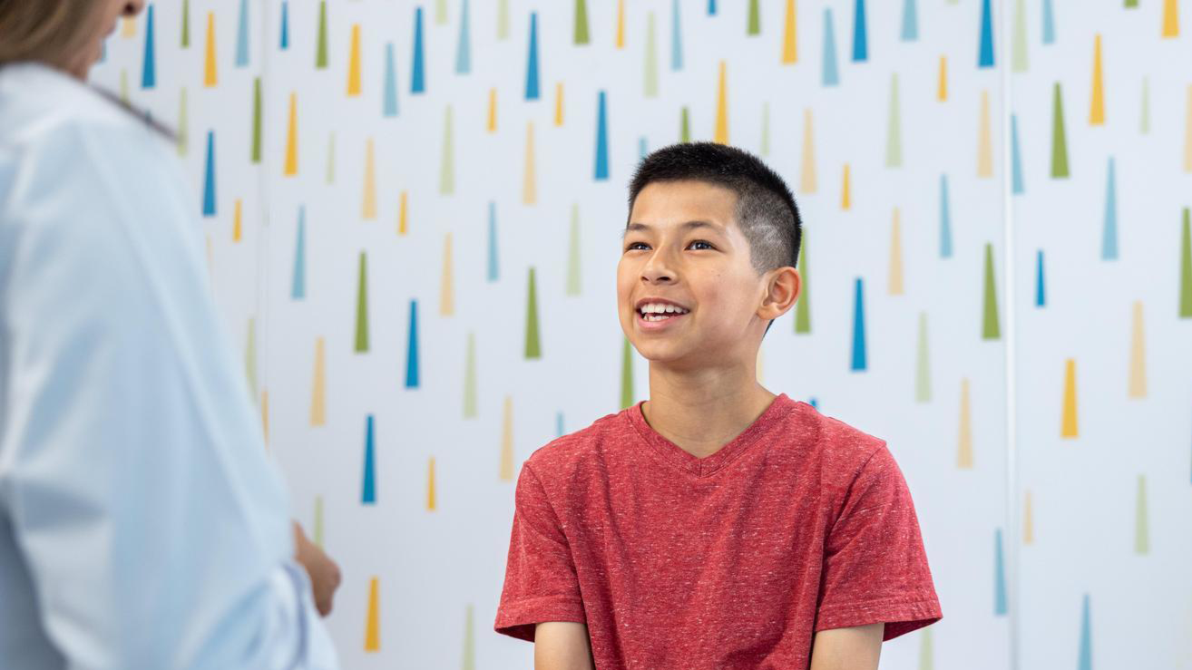 adolescent boy speaking with provider