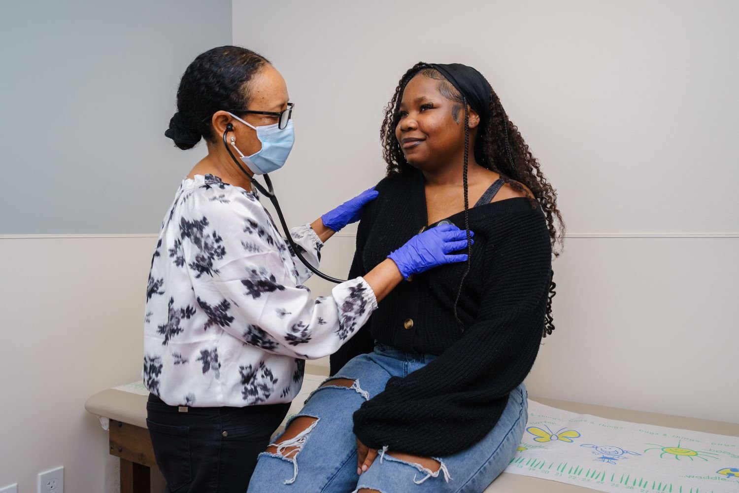 doctor examines teen patient