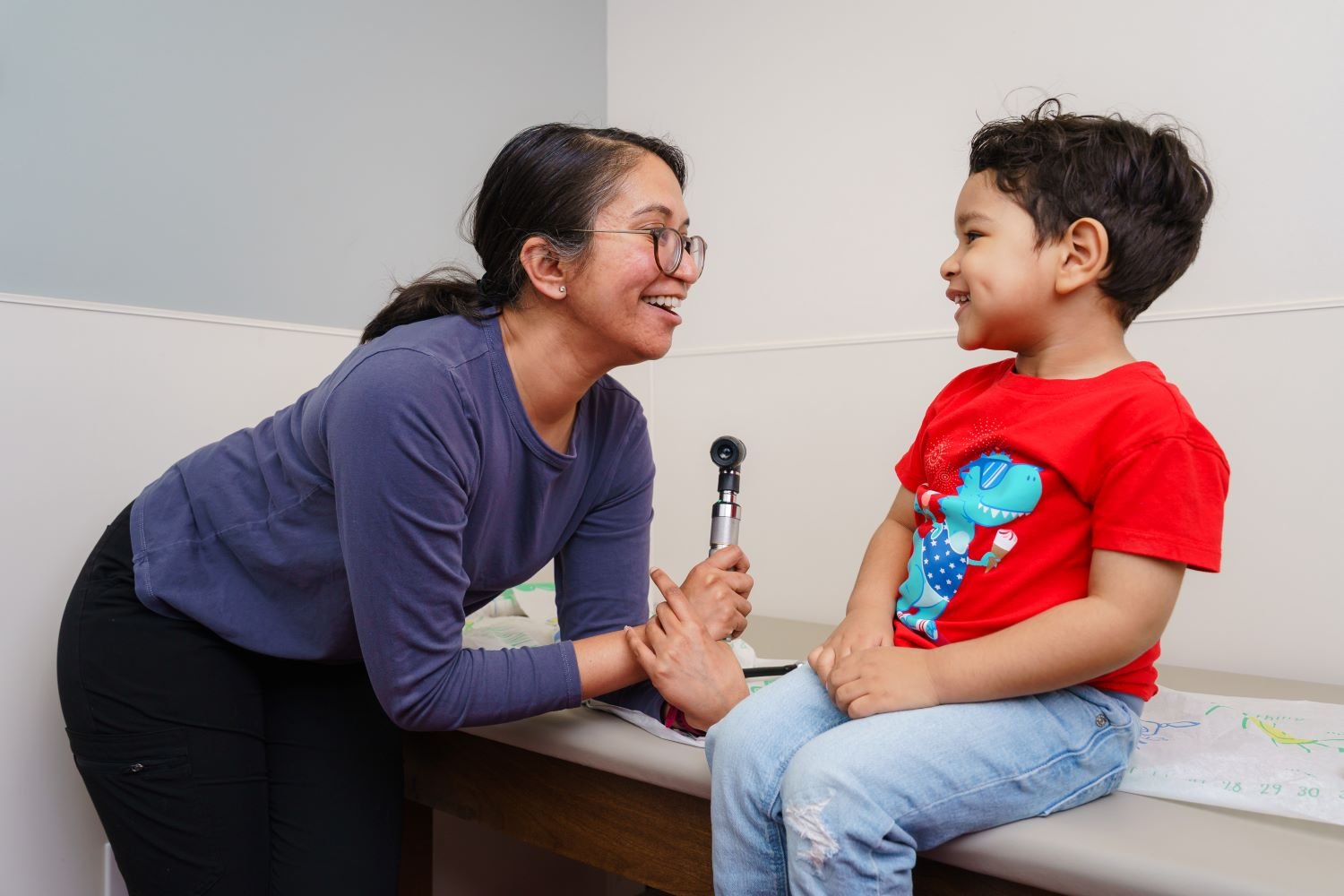 doctor smiles at young patient