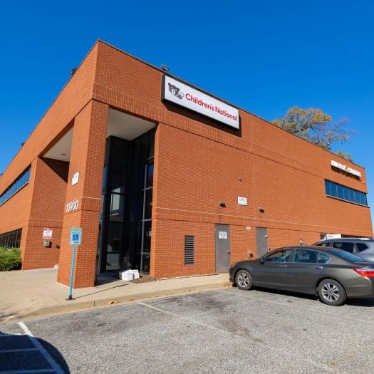 Photograph of brick exterior of CNPA Laurel office building with a blue sky in the background.