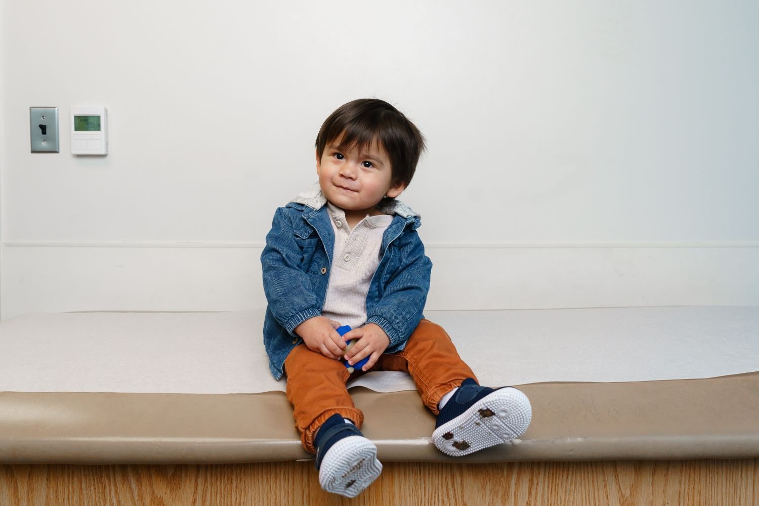 toddler sitting on exam table