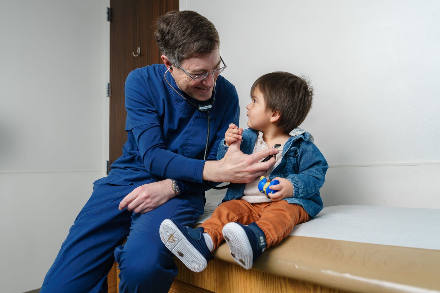 doctors listens to toddler patient's heart