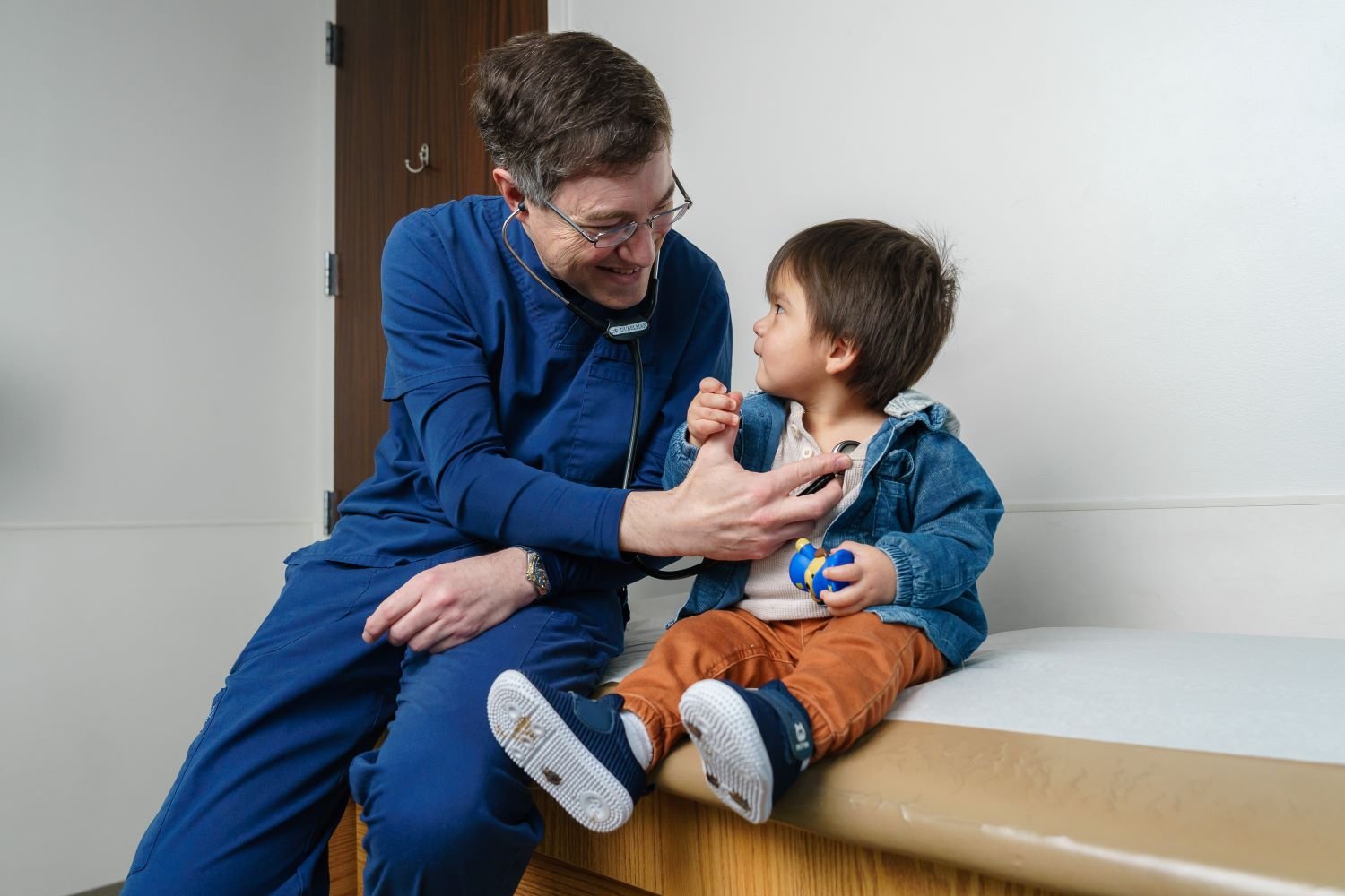 doctors listens to toddler patient's heart
