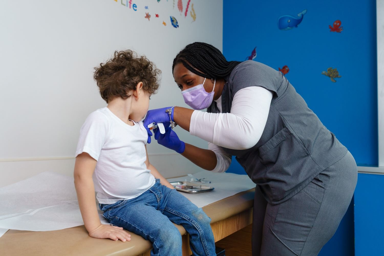 young boy receives vaccine