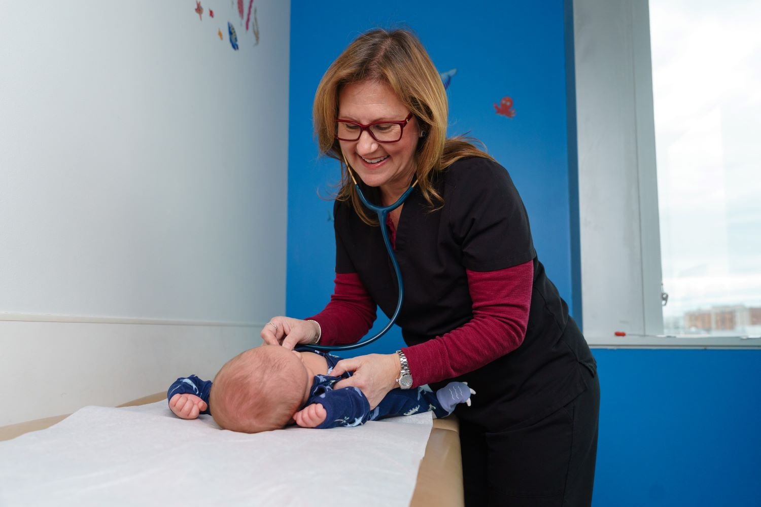 doctor listens to baby's heart