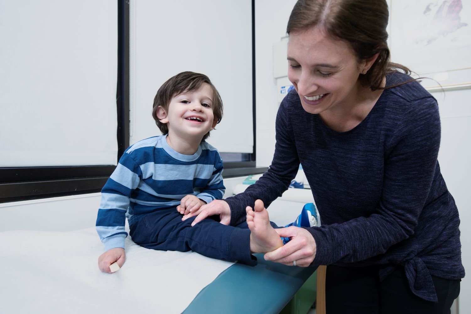 doctor examines young boy's foot