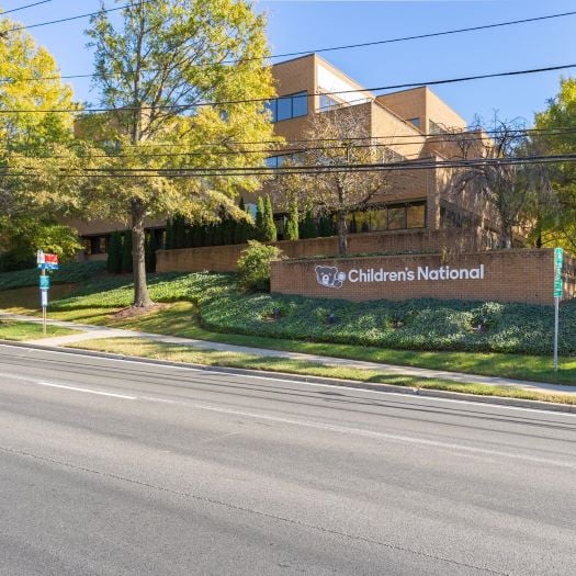 Photograph of the Children's National sign on a brick wall outside of the CNPA Silver Spring office.