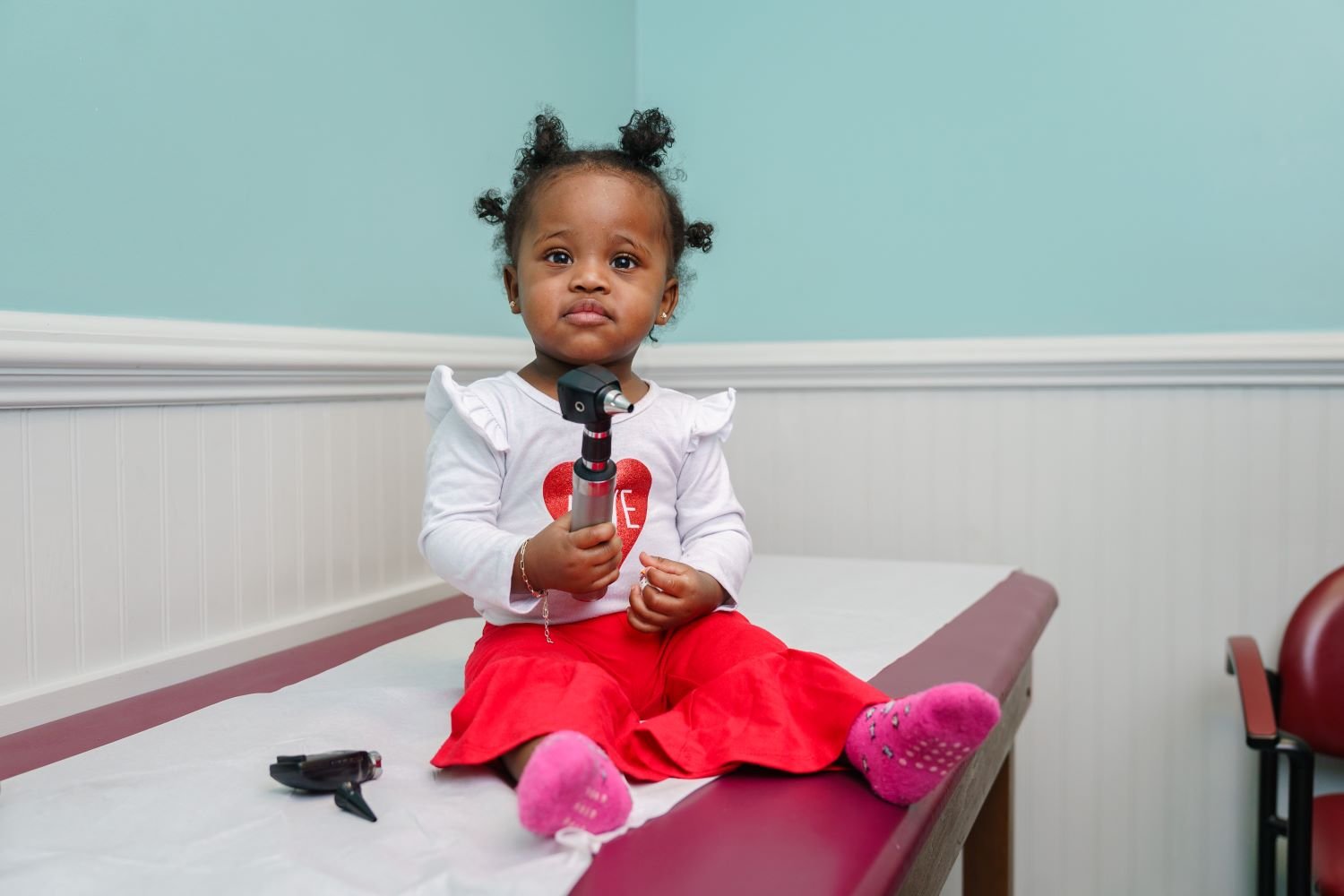 toddler sitting on exam table