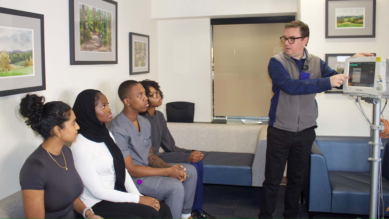 Ioannis Koutroulis, MD, PhD, conducts a vital signs training for the ED Research interns to ensure they understand how to obtain vital signs from a research subject during an enrollment.