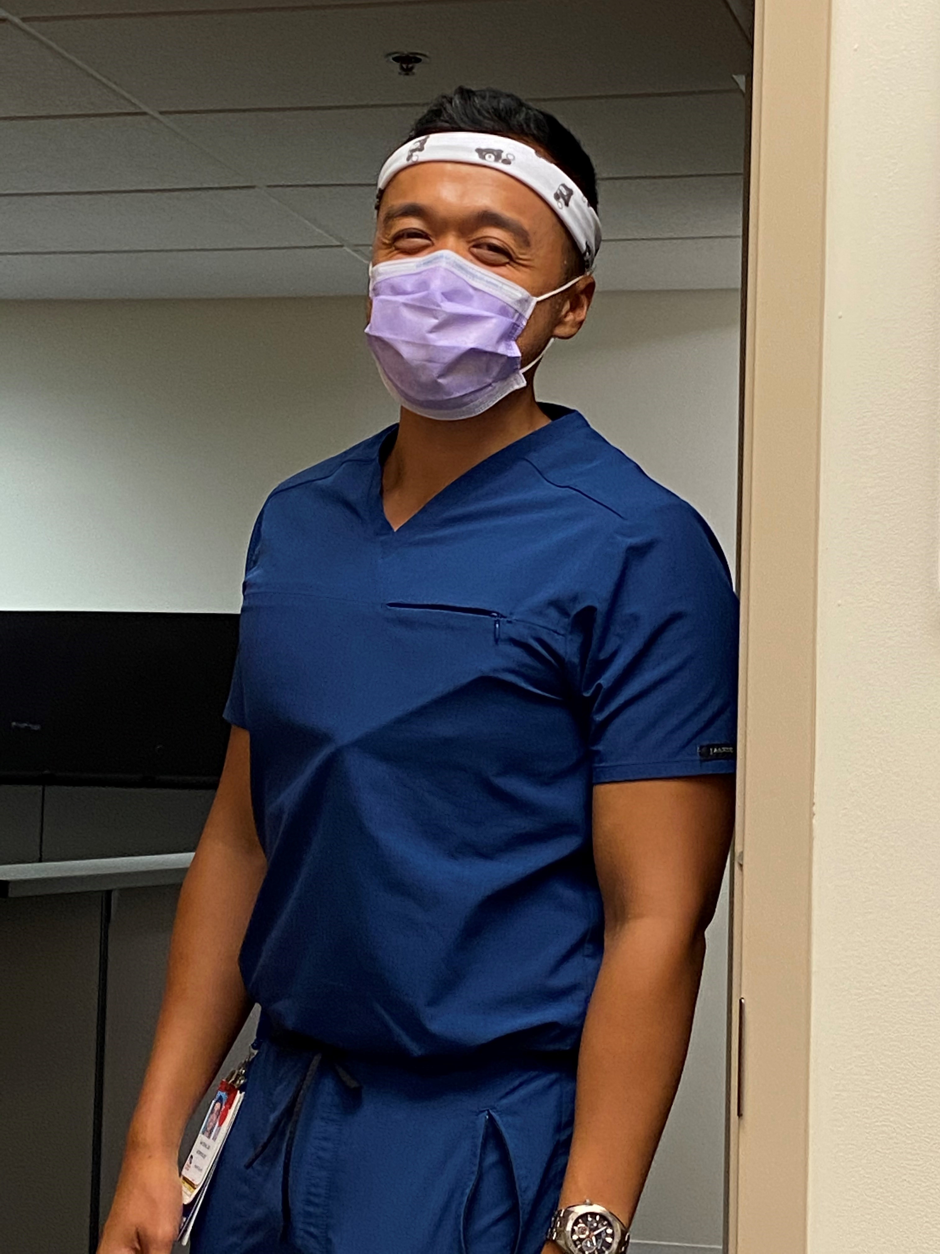 Fellow in a mask and scrubs