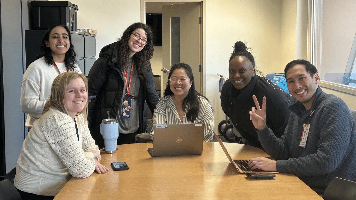 Fellows sitting around a conference table
