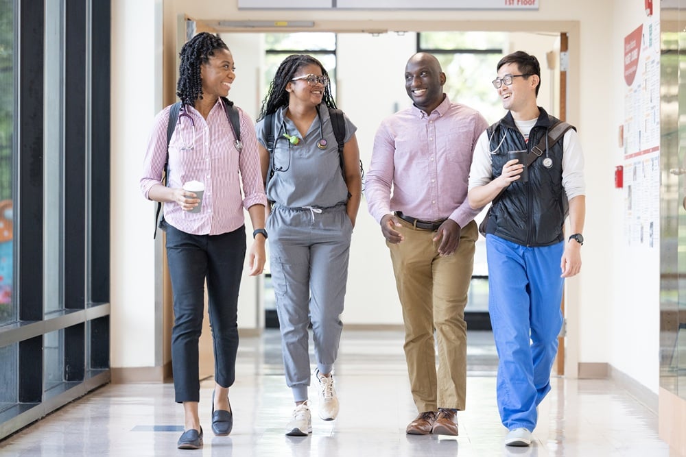 Four pediatric residency program residents walking in a hallway at Children's National Hospital